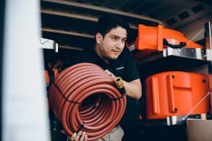 commercial restoration technician taking equipment out of vehicle