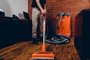 commercial restoration technician extracting water from office