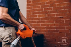 water damage restoration technician extracting water in office