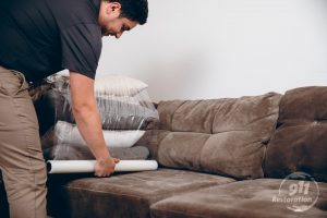 restoration technician packing up furniture